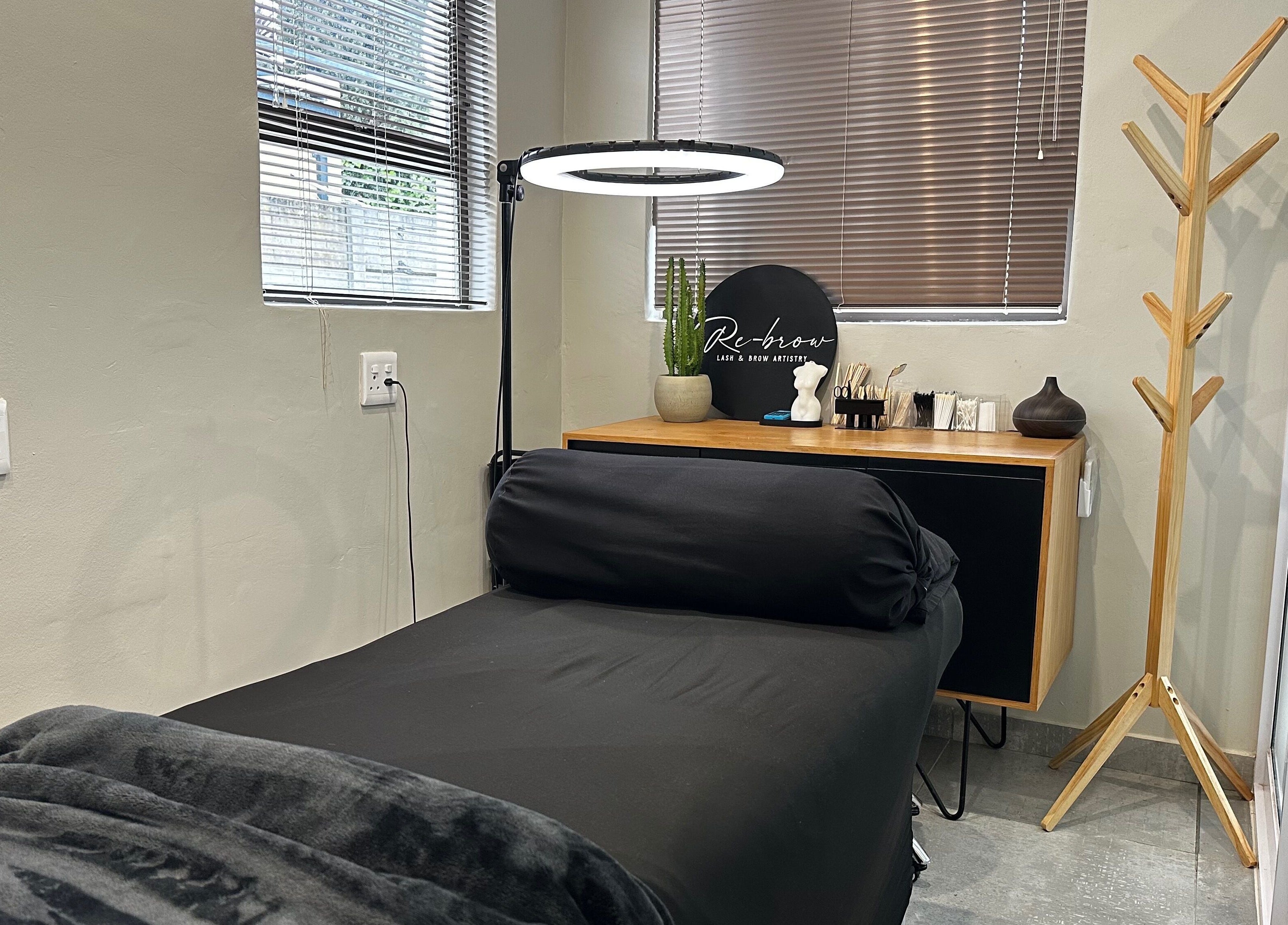 Relaxing treatment room at Re Brow Lash & Brow Artistry in Cape Town, Western Cape, ZA showcasing a plush bed.