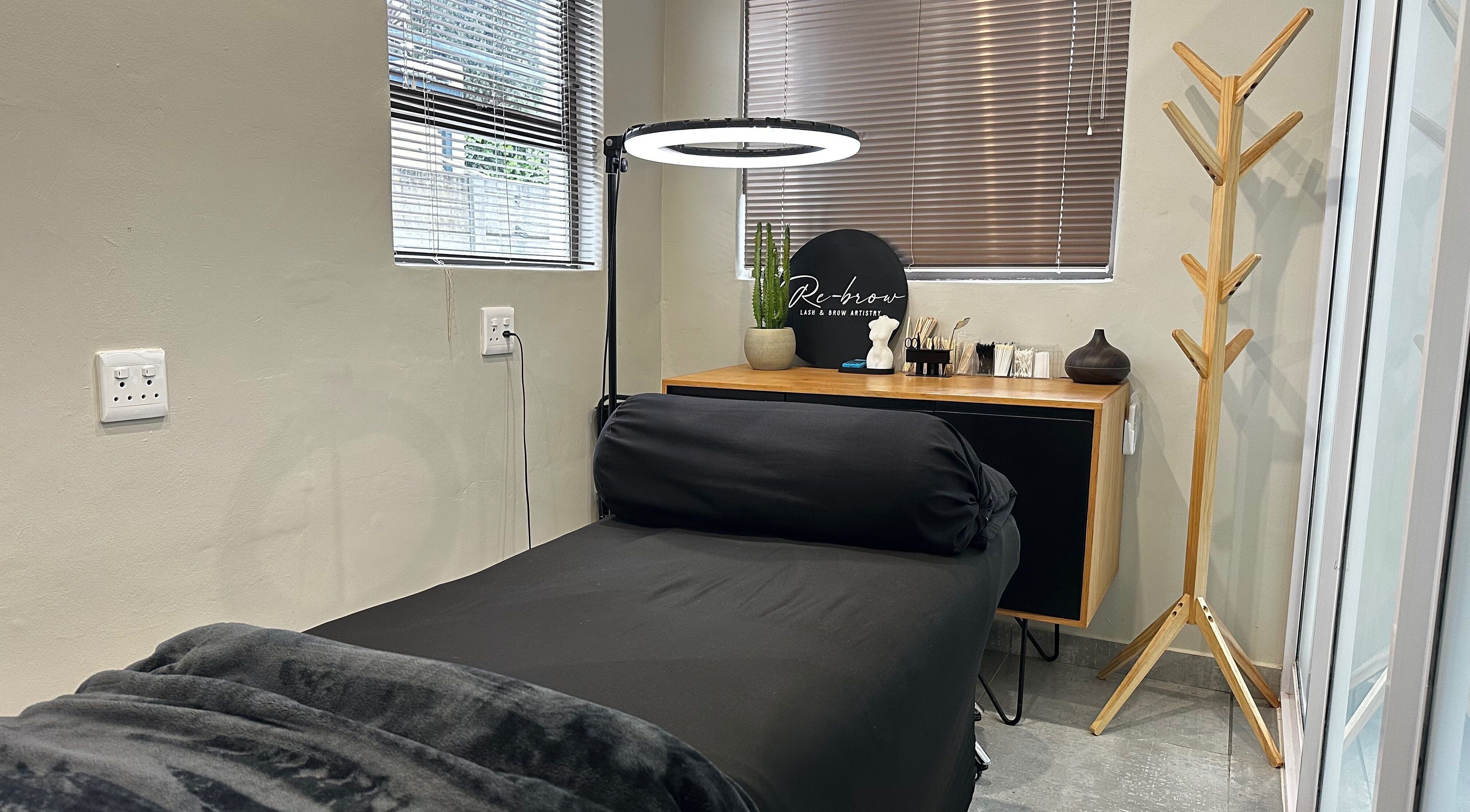 Relaxing treatment room at Re Brow Lash & Brow Artistry in Cape Town, Western Cape, ZA showcasing a plush bed.