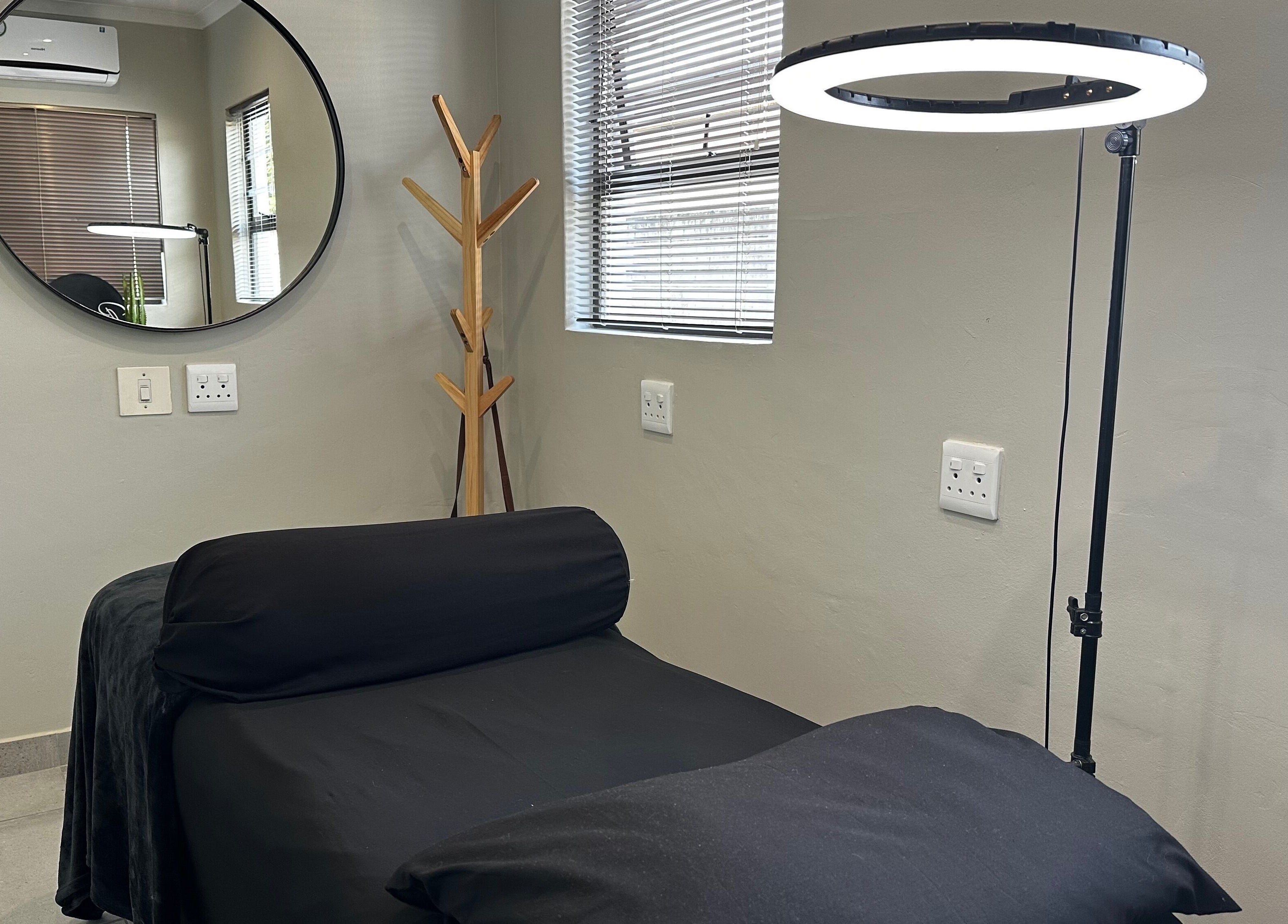 Cozy treatment room at Re Brow Lash & Brow Artistry, Cape Town, Western Cape, ZA with modern decor and ambient lighting.