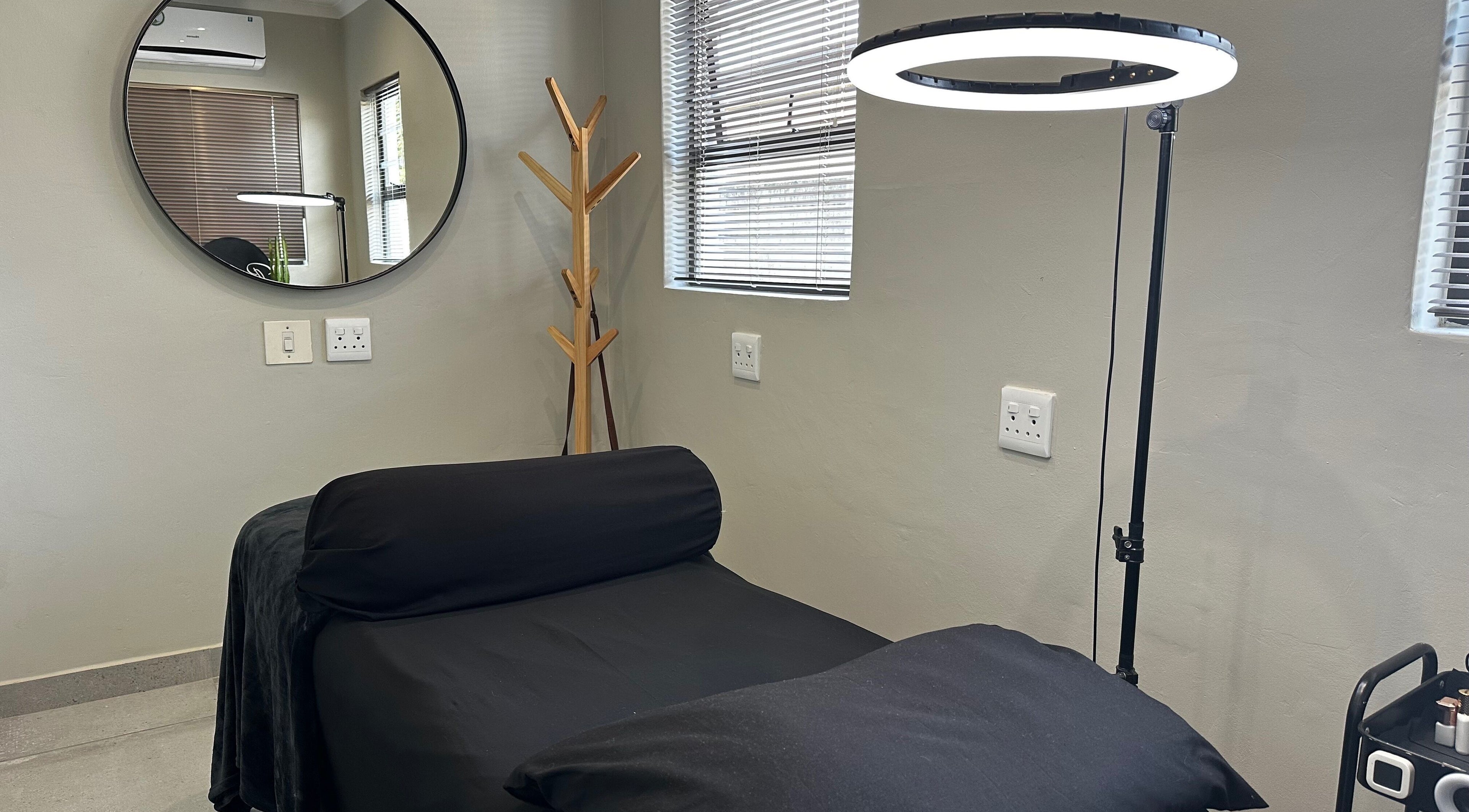 Cozy treatment room at Re Brow Lash & Brow Artistry, Cape Town, Western Cape, ZA with modern decor and ambient lighting.