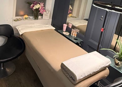 Relaxing treatment room at Ella’s Beauty, London, England, GB, featuring a massage table and ambient decor.