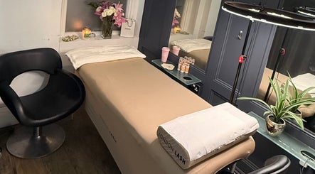 Relaxing treatment room at Ella’s Beauty, London, England, GB, featuring a massage table and ambient decor.