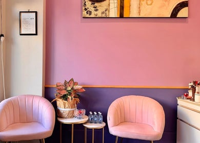 Elegant lounge area at Pailin Thai Wellness, South Yarra, Victoria, AU featuring soft pink chairs and decor.
