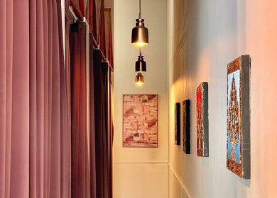 Elegant hallway with art at Pailin Thai Wellness, South Yarra, Victoria, AU. Soft lighting creates a relaxing ambiance.