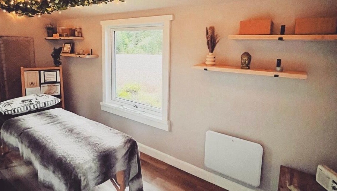 Therapy room at Breathe and Bloom Holistics, Wakefield, England, GB. Serene setting with massage table and decor.