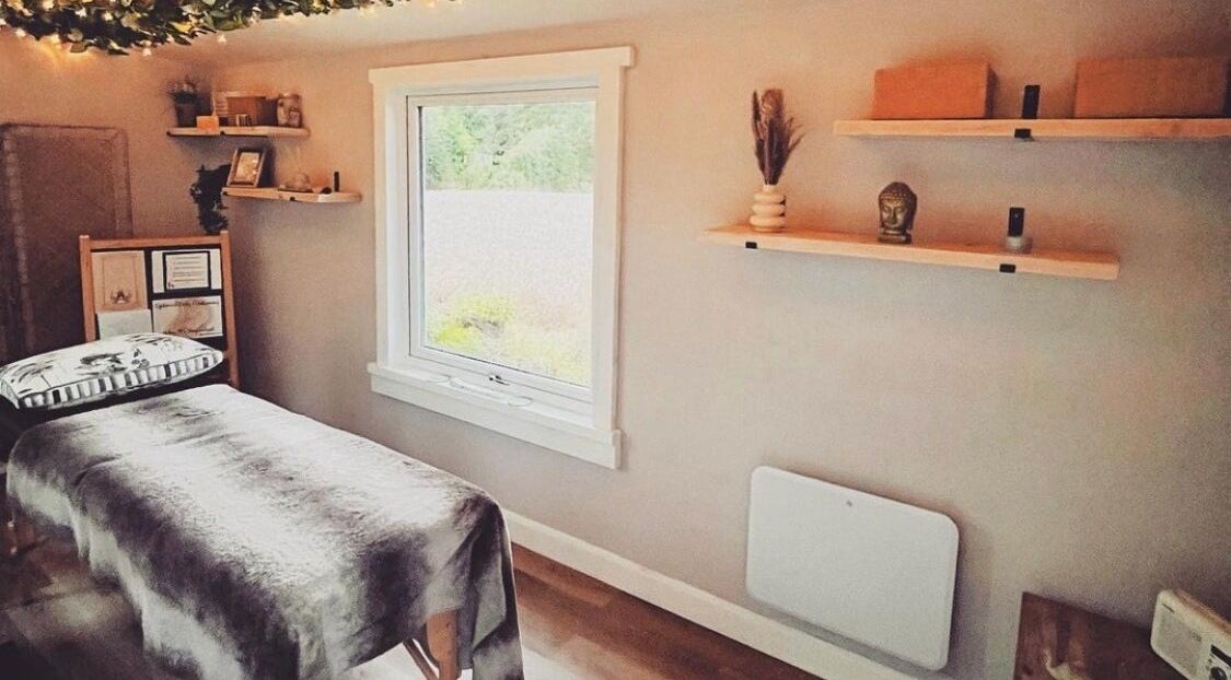 Therapy room at Breathe and Bloom Holistics, Wakefield, England, GB. Serene setting with massage table and decor.