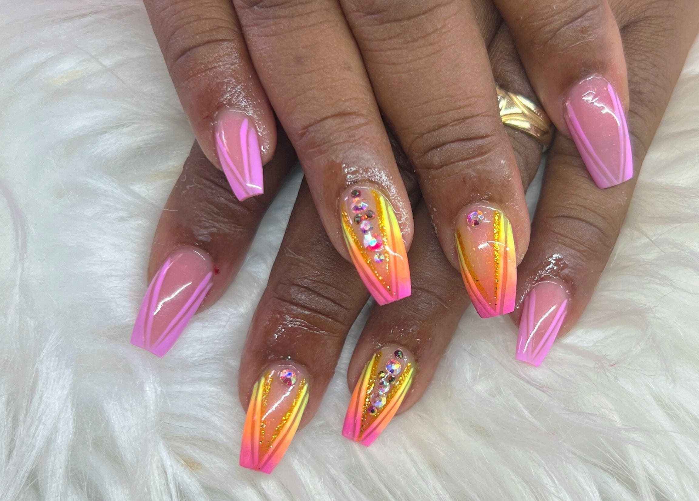 Colorful nail art at The Nail & Lash Studio in Saint Philip, Saint Philip, BB featuring pink and orange designs.