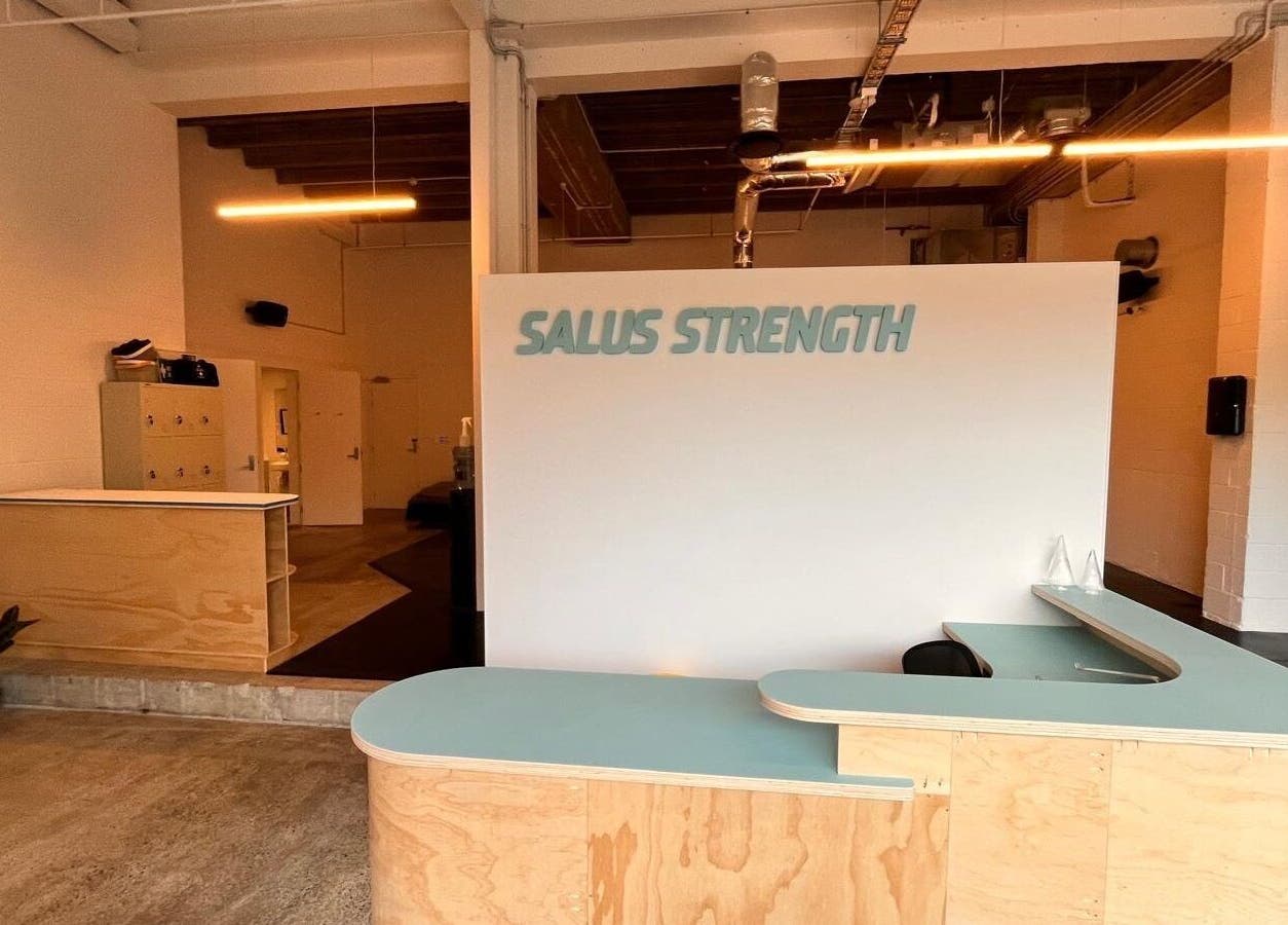 Reception area of Salus Strength in Auckland, Auckland, NZ featuring modern wood decor and sleek design.