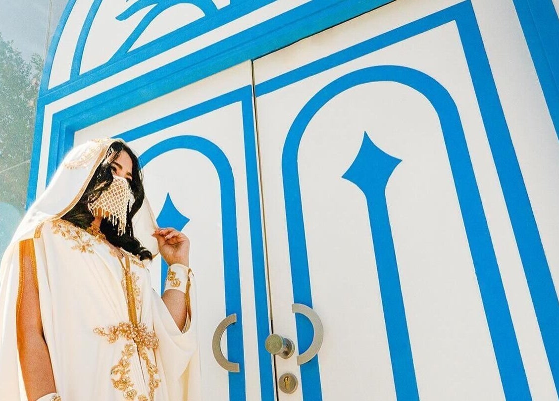 Sophisticated woman in elegant white attire at LYA Spa & Salon entrance, Riyadh, Riyadh Province, SA.