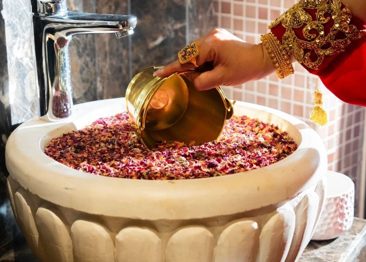Elegant LYA Spa & Salon ritual in Riyadh showcasing flower petals and golden bowl for luxurious treatments.