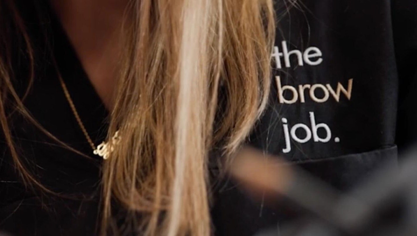 Logo on uniform at the brow job, Chester, England, GB showcasing branding.