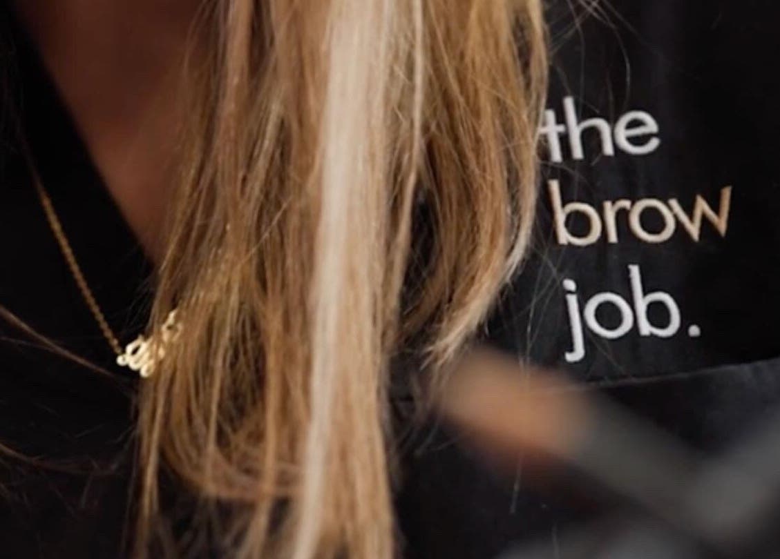 Logo on uniform at the brow job, Chester, England, GB showcasing branding.