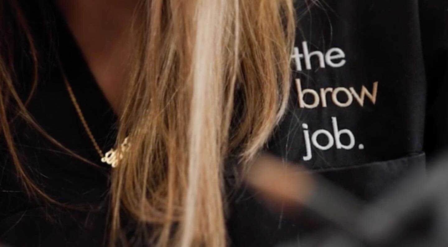 Logo on uniform at the brow job, Chester, England, GB showcasing branding.