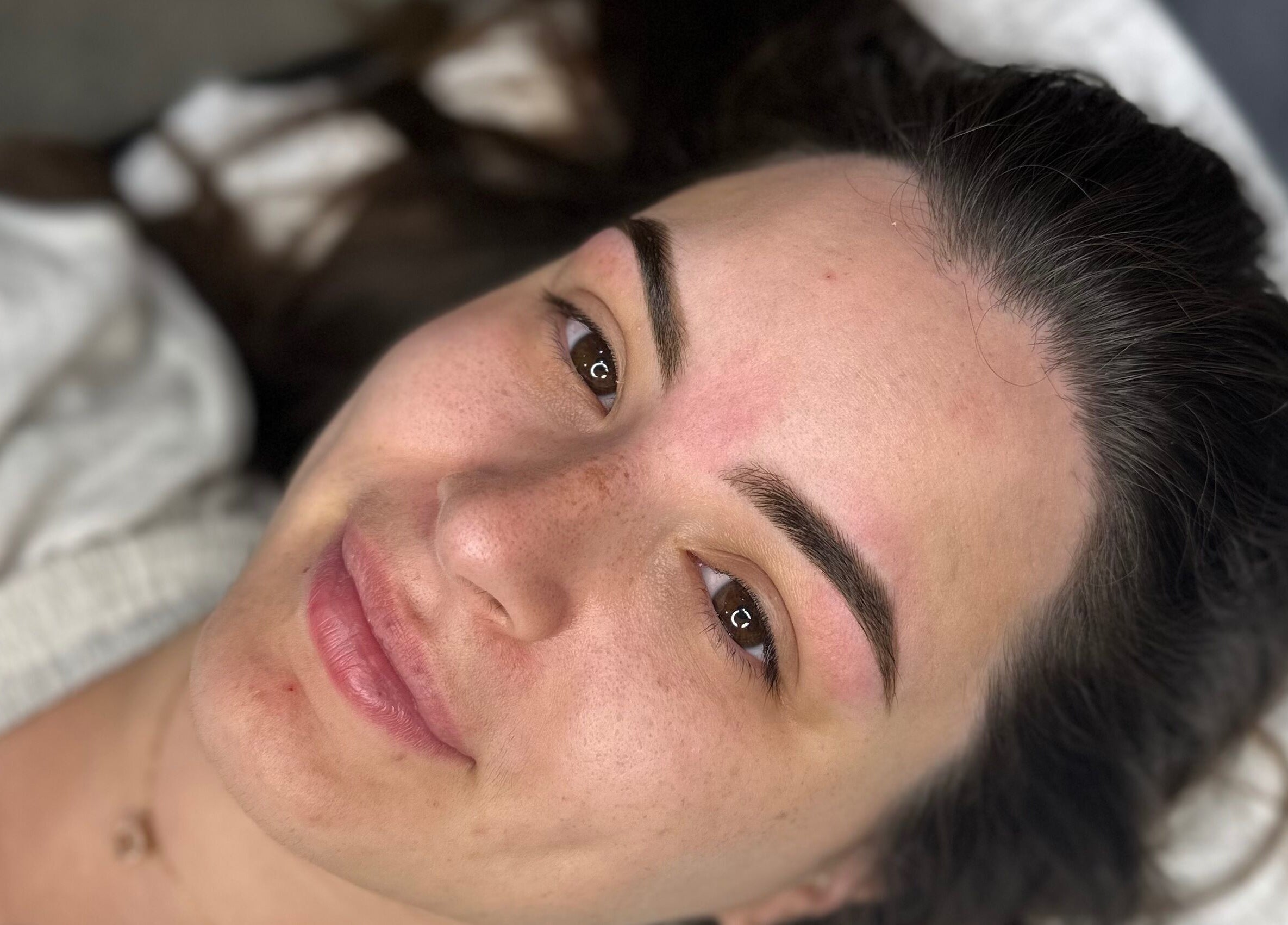 A woman's radiant face post-treatment at Ivory Rose Cosmetics, Maroochydore, Queensland, AU.