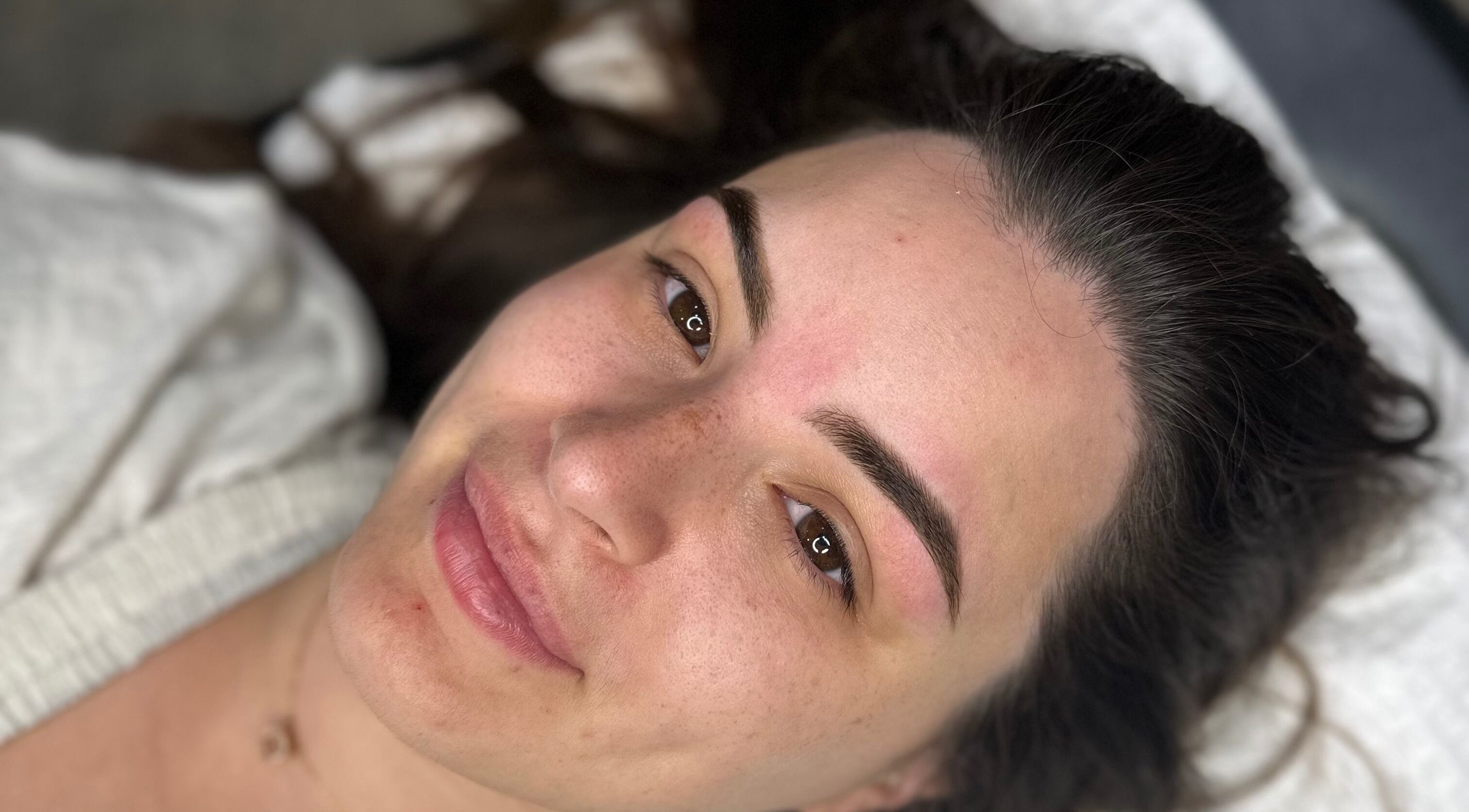 A woman's radiant face post-treatment at Ivory Rose Cosmetics, Maroochydore, Queensland, AU.