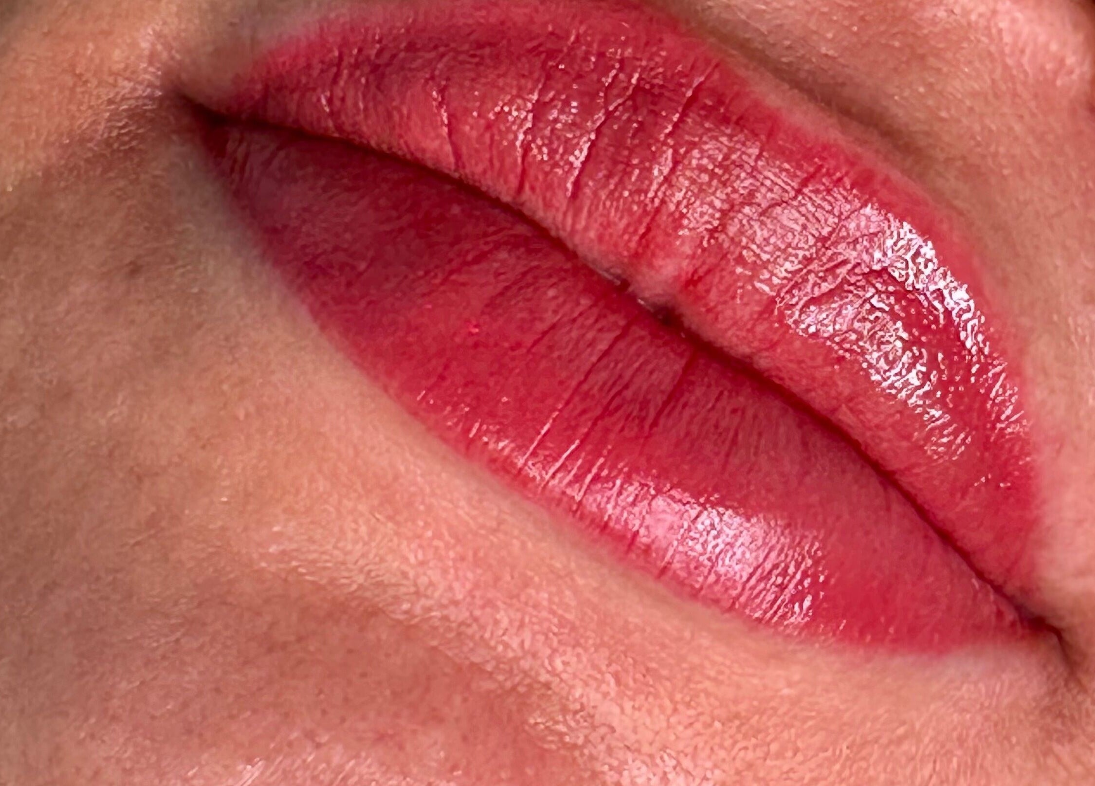 Close-up of glossy red lips at Annaflex, London, England, GB, showcasing flawless lip makeup.