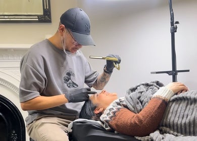 Brow artist at Amanda Corrêa - ACBrows & Beauty in Dublin performing precise beauty treatment on a client.