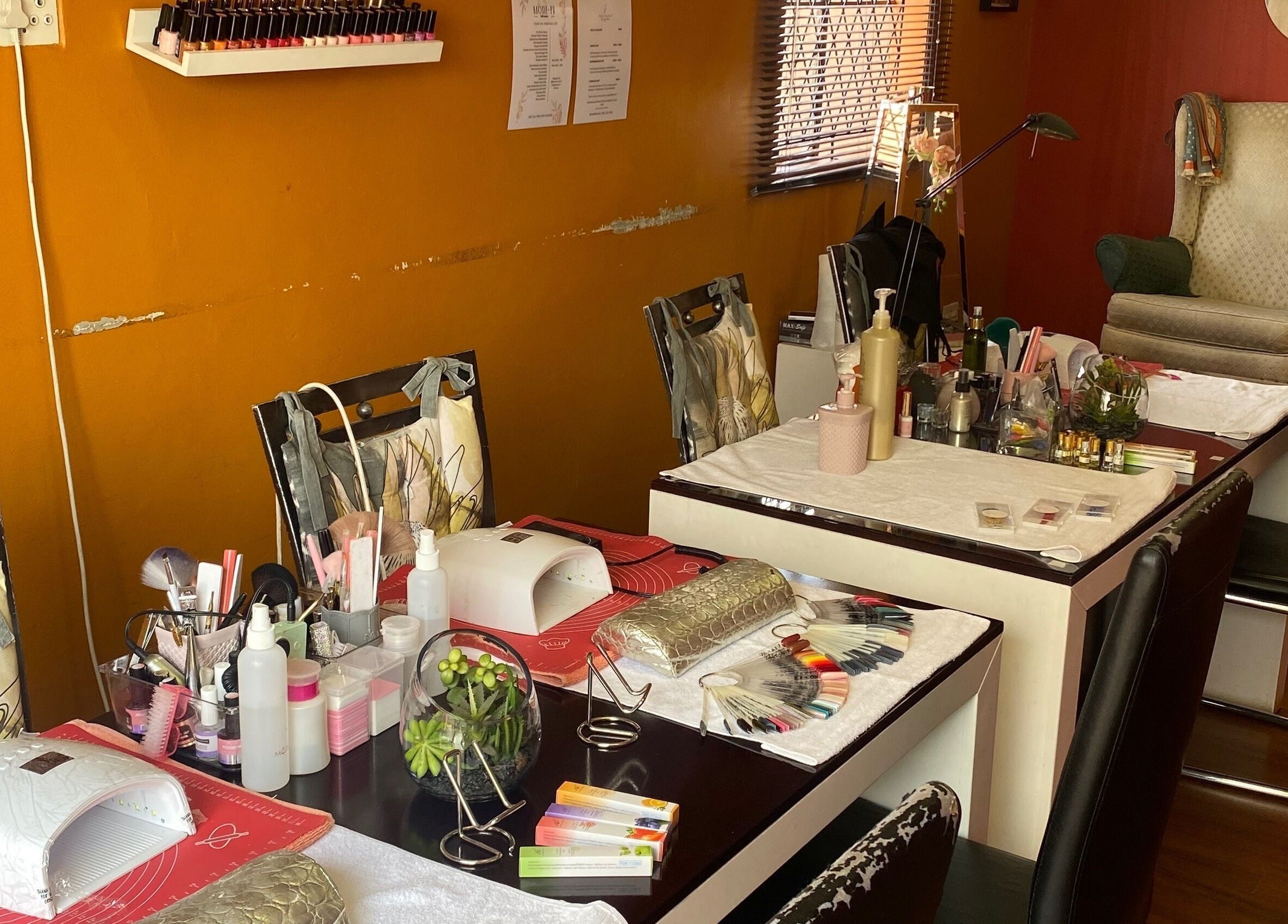 Cozy nail spaces at Modi Fi Nail And Beauty Bar, Soweto, Gauteng, ZA with manicure tools and polishes.