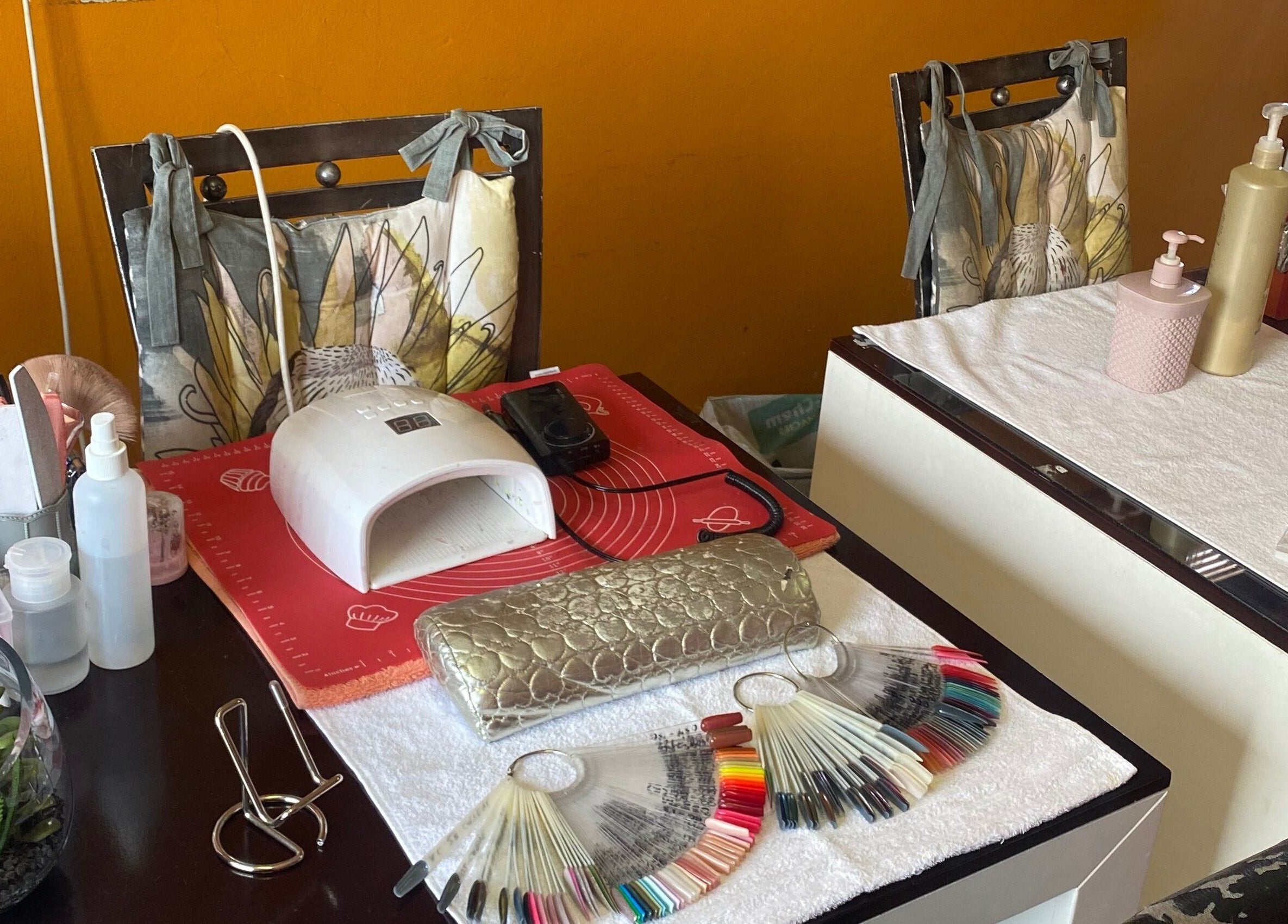 Nail station at Modi Fi Nail And Beauty Bar in Soweto, Gauteng, ZA with tools and polish samples.