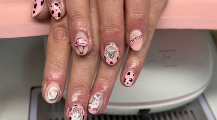 Cowgirl-themed nail art at Nails by Georgia in Colne, England, GB. Pink polish with intricate western designs.