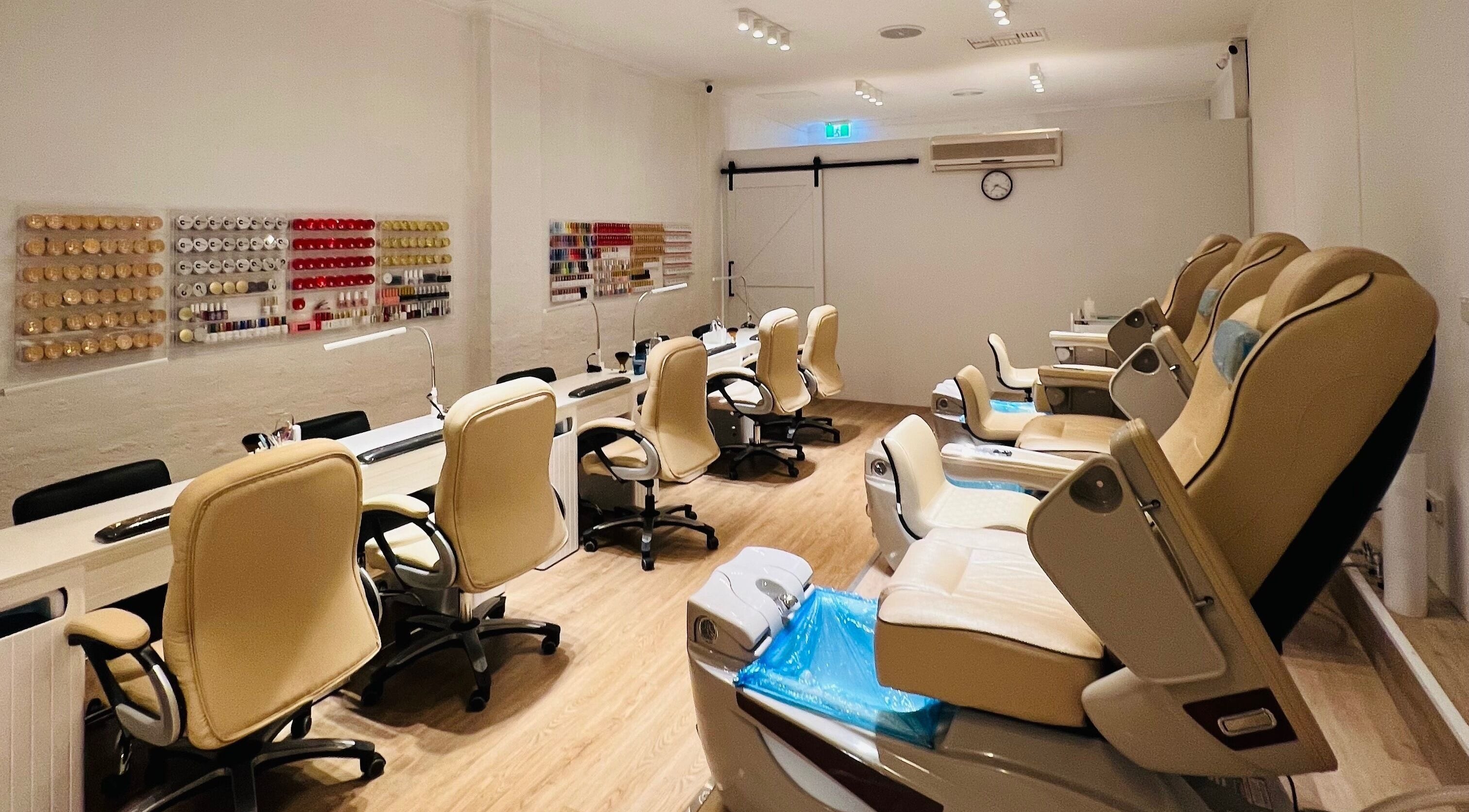 Luxurious nail salon at The Bean Nails, Midland, Western Australia, AU, featuring plush chairs and nail polish display.