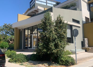 Η είσοδος του BLING IT στην Ηράκλειο, GR με μοντέρνο αρχιτεκτονικό στιλ και φυτά.