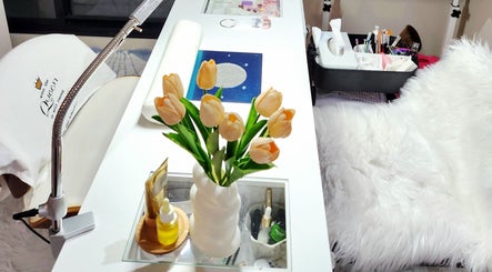 Chic nail station at NailxSejal, Melbourne, Victoria, AU, with white decor and yellow tulips.