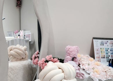 Chic nail salon decor at NailxSejal, Melbourne, Victoria, AU, featuring plush seating and floral accents.