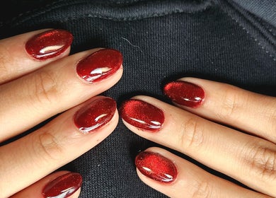 Red polished nails at NailxSejal, Melbourne, Victoria, AU offer a touch of elegance and style.