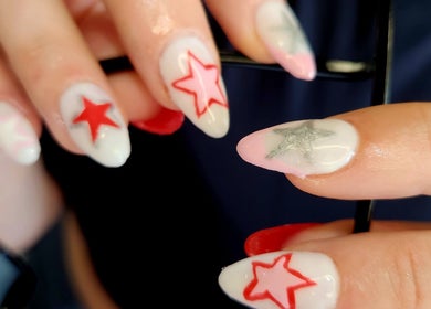 Star-themed nail art design at NailxSejal, Melbourne, Victoria, AU. Bright red stars on a white base.