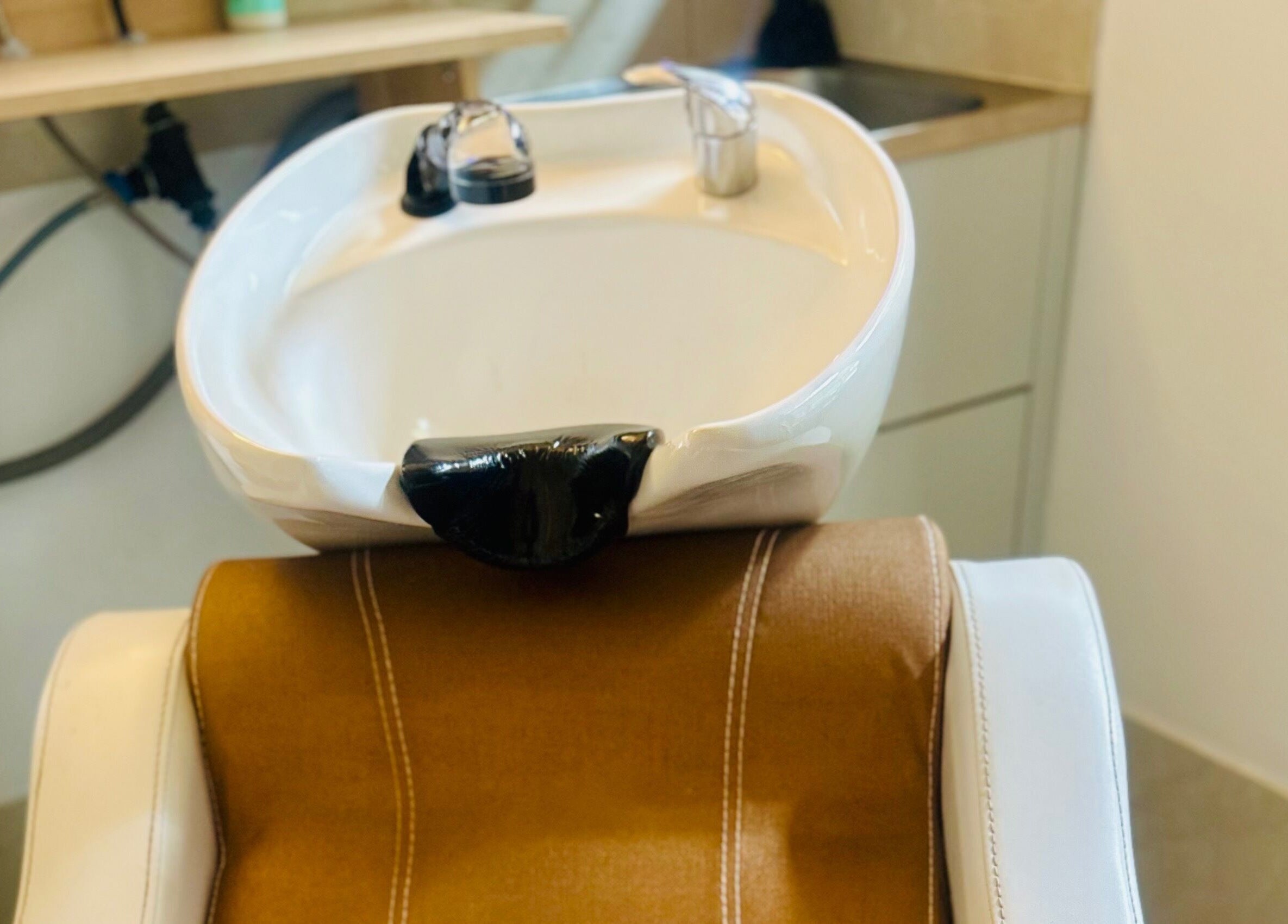 Modern hair wash station at Nest Hair, Shailer Park, Queensland, AU, featuring sleek and comfortable design.