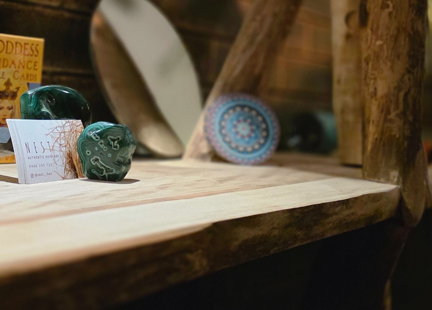 Close-up of a tranquil display at Nest Hair, Shailer Park, Queensland, AU, with crystals and decor.