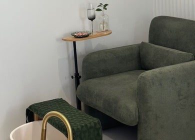 Comfortable green armchair at Sands Beauty Lounge in Torquay, Victoria, AU, set for a relaxing pedicure.