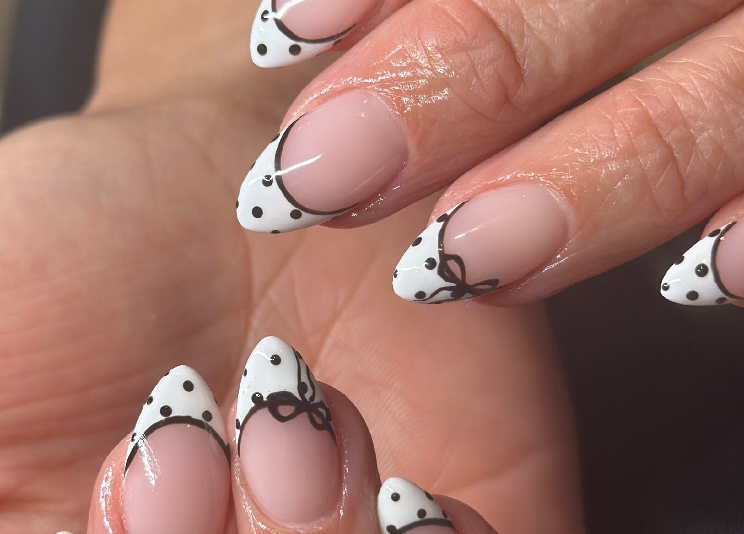 Elegant polka dot nail design at The Lux Cocoon, Newtown, Victoria, AU. Perfect for a stylish look.