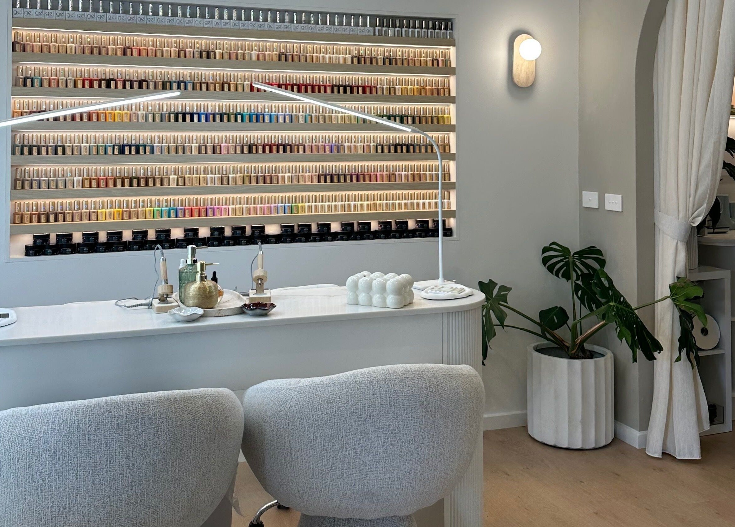 Elegant nail salon at The Lux Cocoon in Newtown, Victoria, AU, featuring a vibrant polish display.