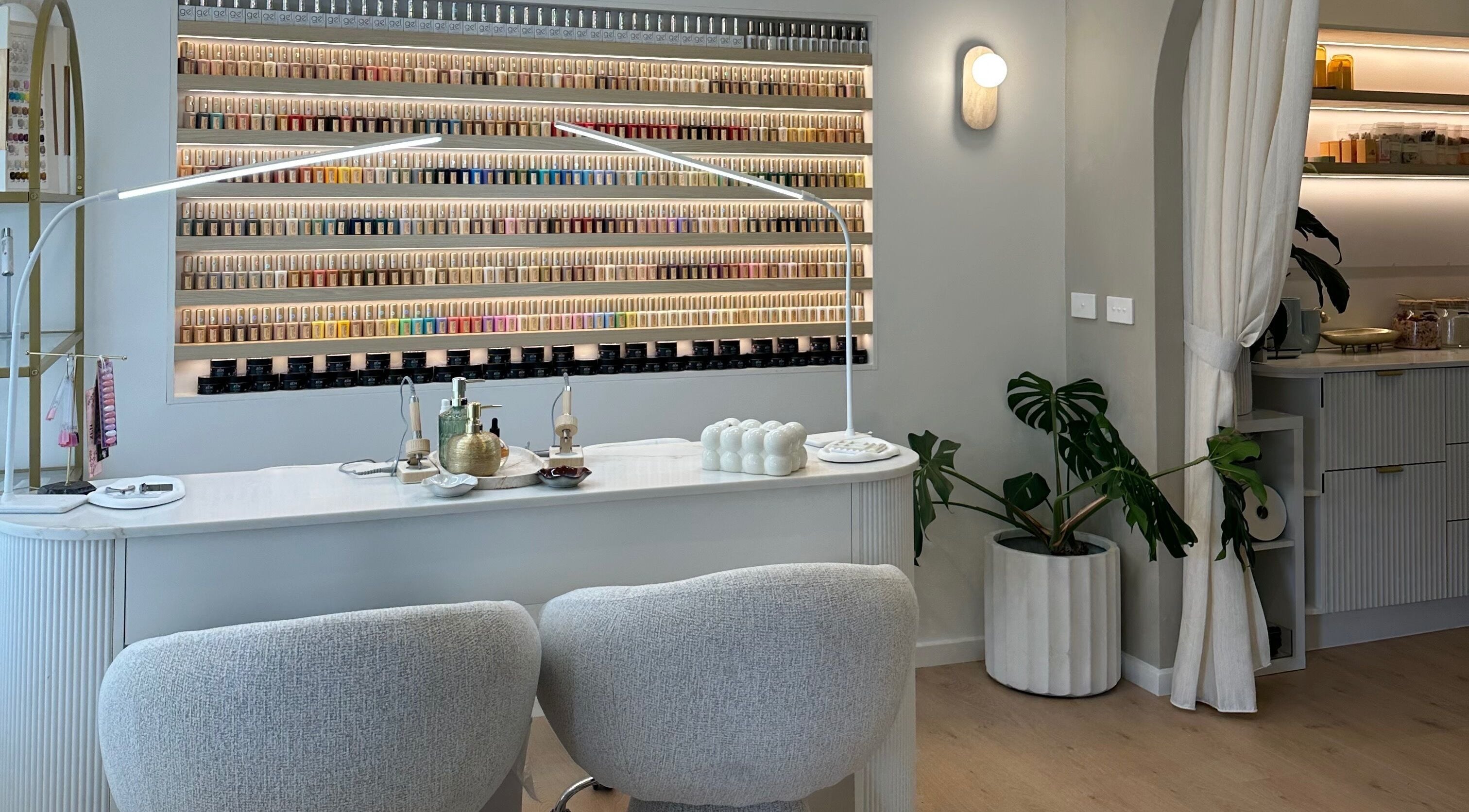 Elegant nail salon at The Lux Cocoon in Newtown, Victoria, AU, featuring a vibrant polish display.