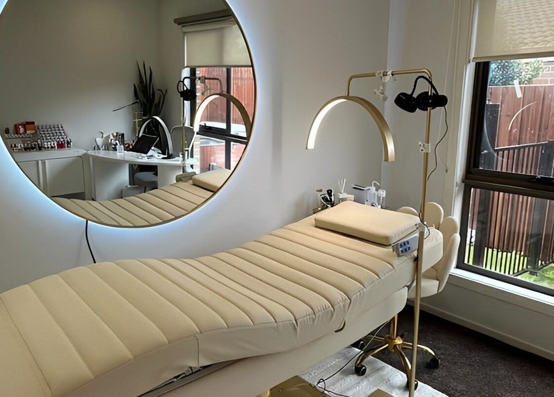 Luxurious spa treatment room at The Lux Cocoon, Newtown, Victoria, AU, featuring elegant decor and plush bed.