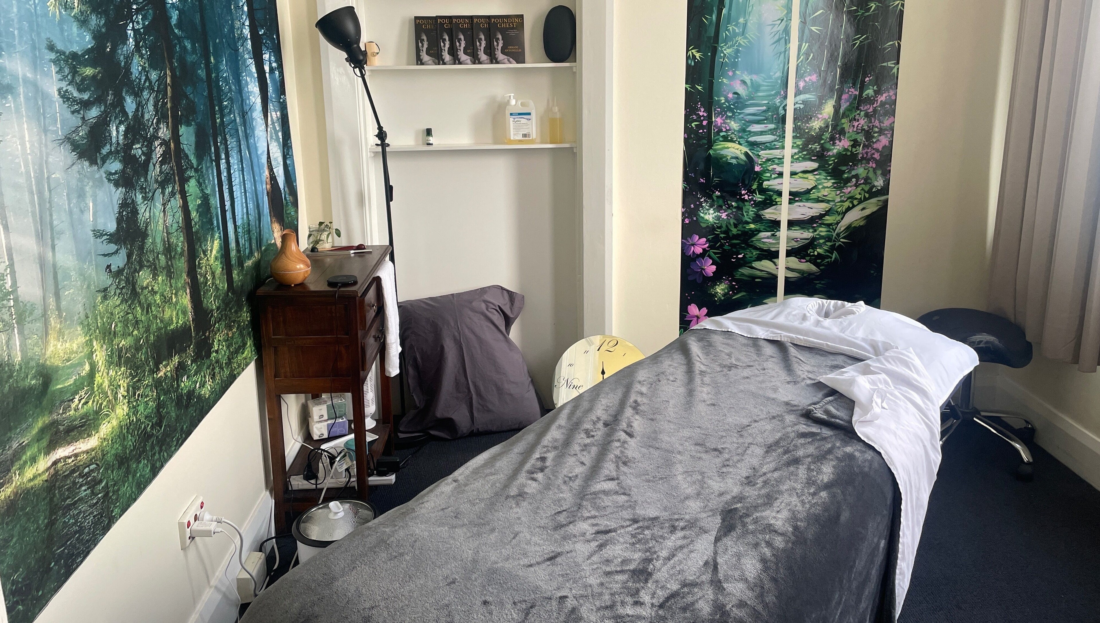 Relaxing massage room at Hobart Massage Guru, Hobart, Tasmania, AU, with tranquil forest decor.
