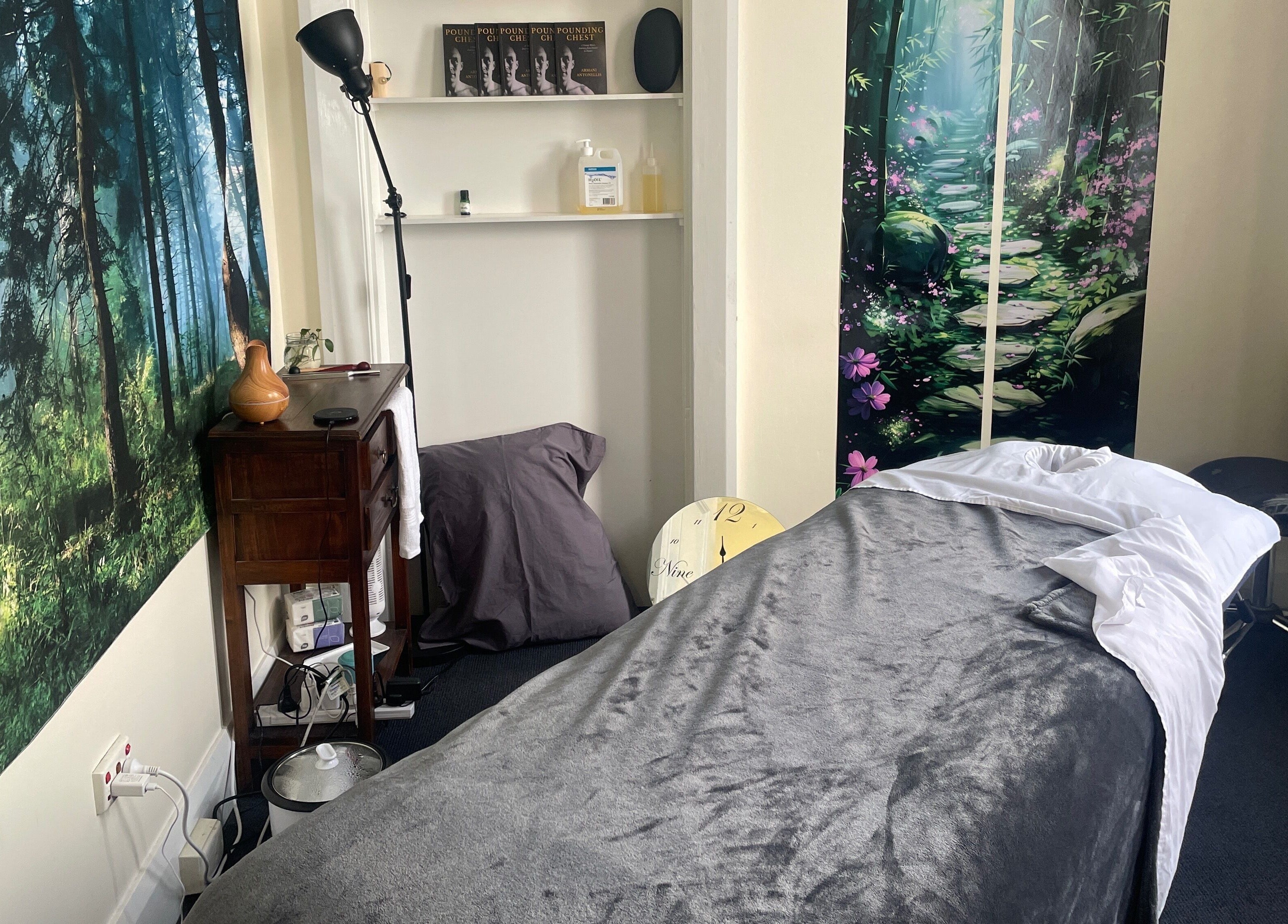 Relaxing massage room at Hobart Massage Guru, Hobart, Tasmania, AU, with tranquil forest decor.