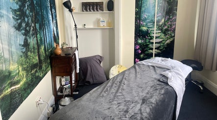 Relaxing massage room at Hobart Massage Guru, Hobart, Tasmania, AU, with tranquil forest decor.
