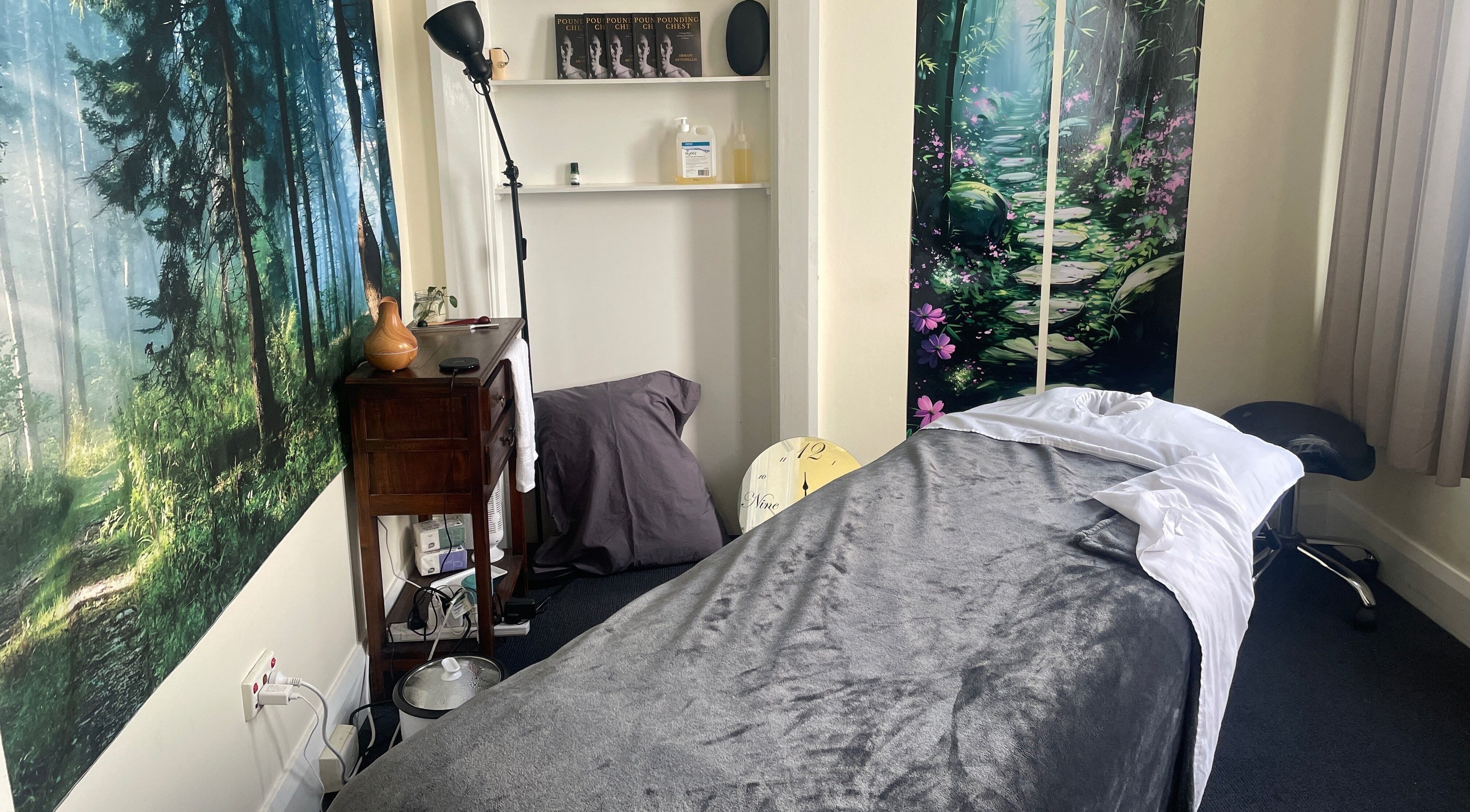 Relaxing massage room at Hobart Massage Guru, Hobart, Tasmania, AU, with tranquil forest decor.