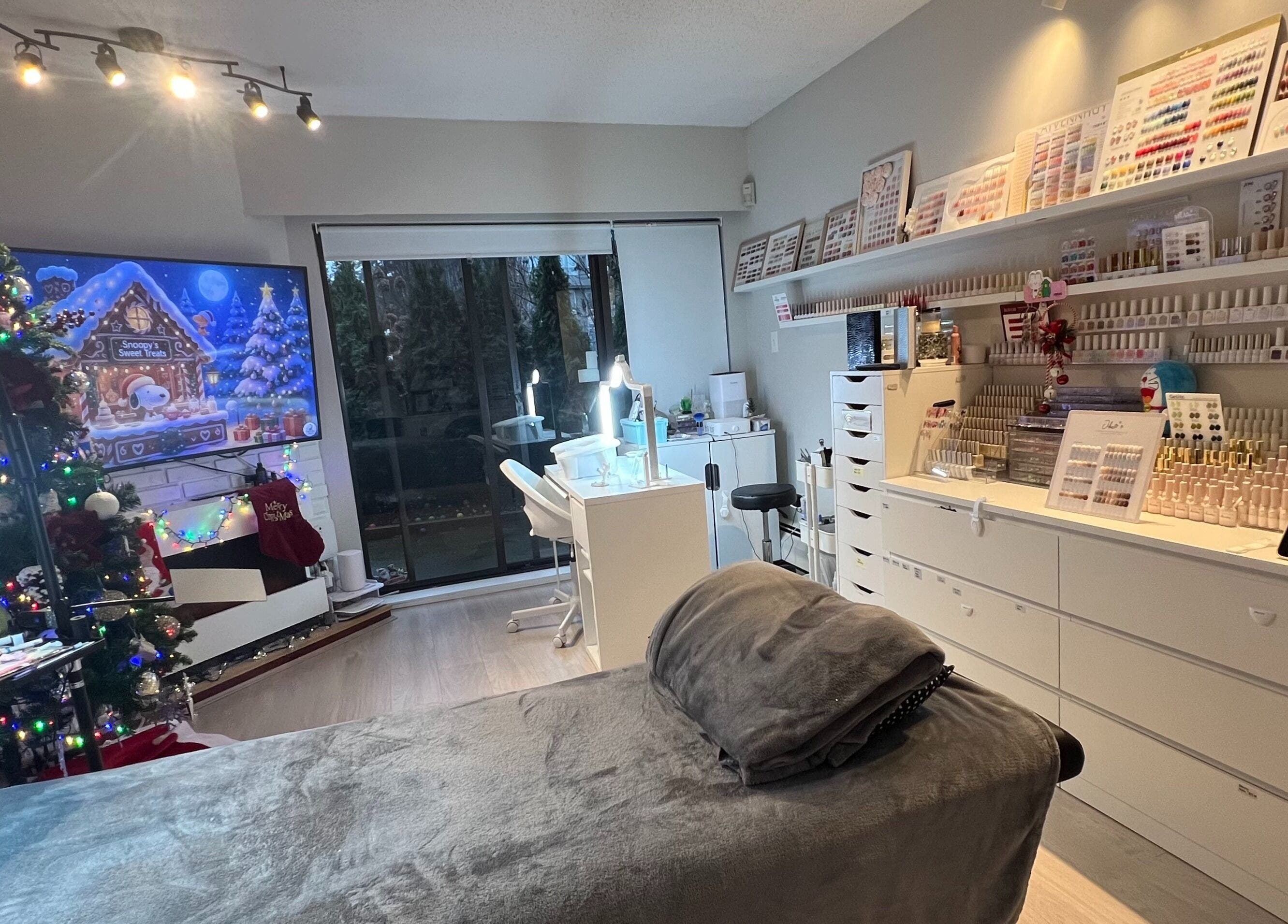 Fi Lash Nail Studio in Vancouver, BC, CA, decorated with holiday decor, elegant nail stations, and cozy ambiance.