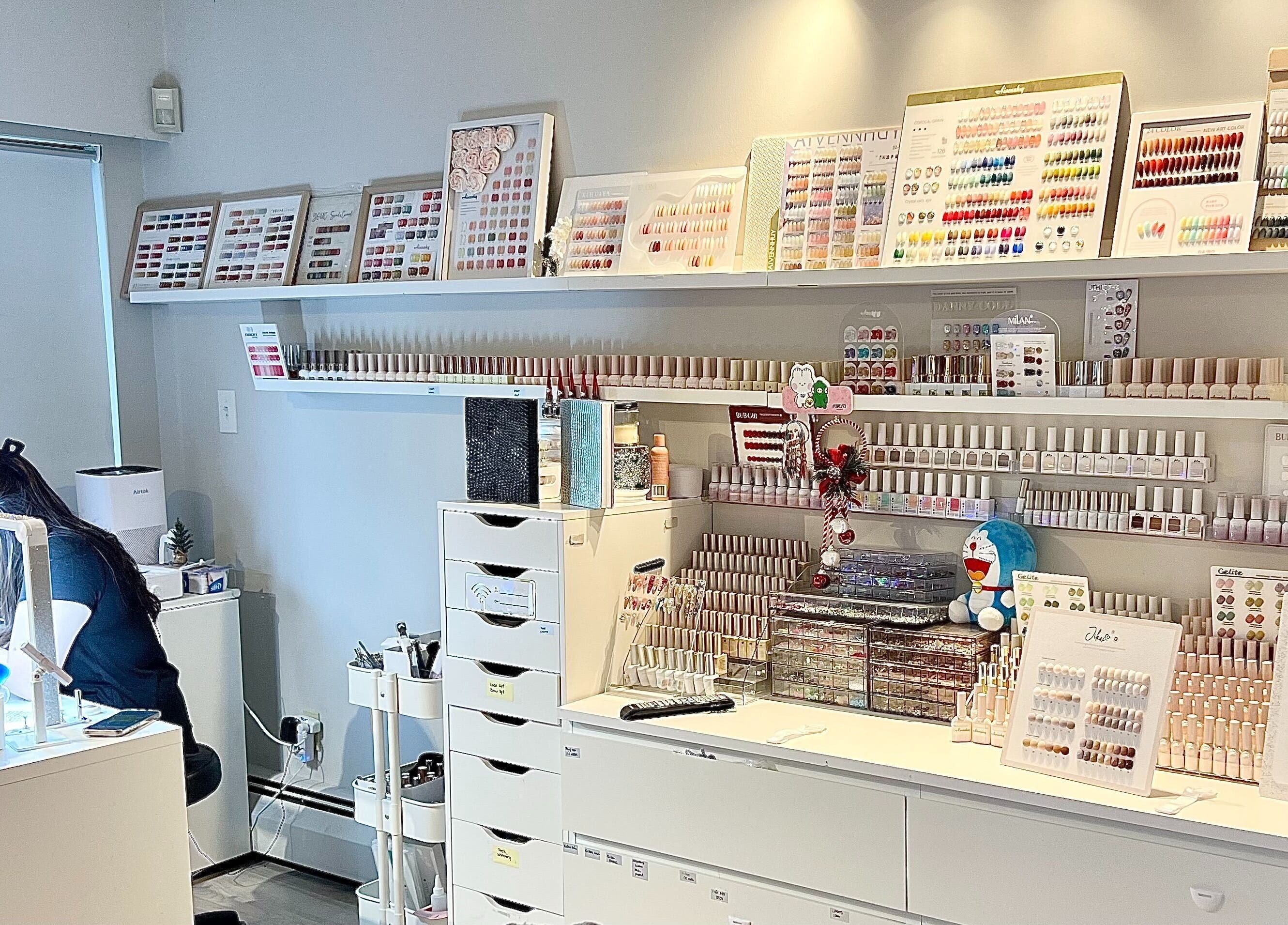 Fi Lash Nail Studio in Vancouver, BC showcases a vibrant nail polish palette and workplace setup.