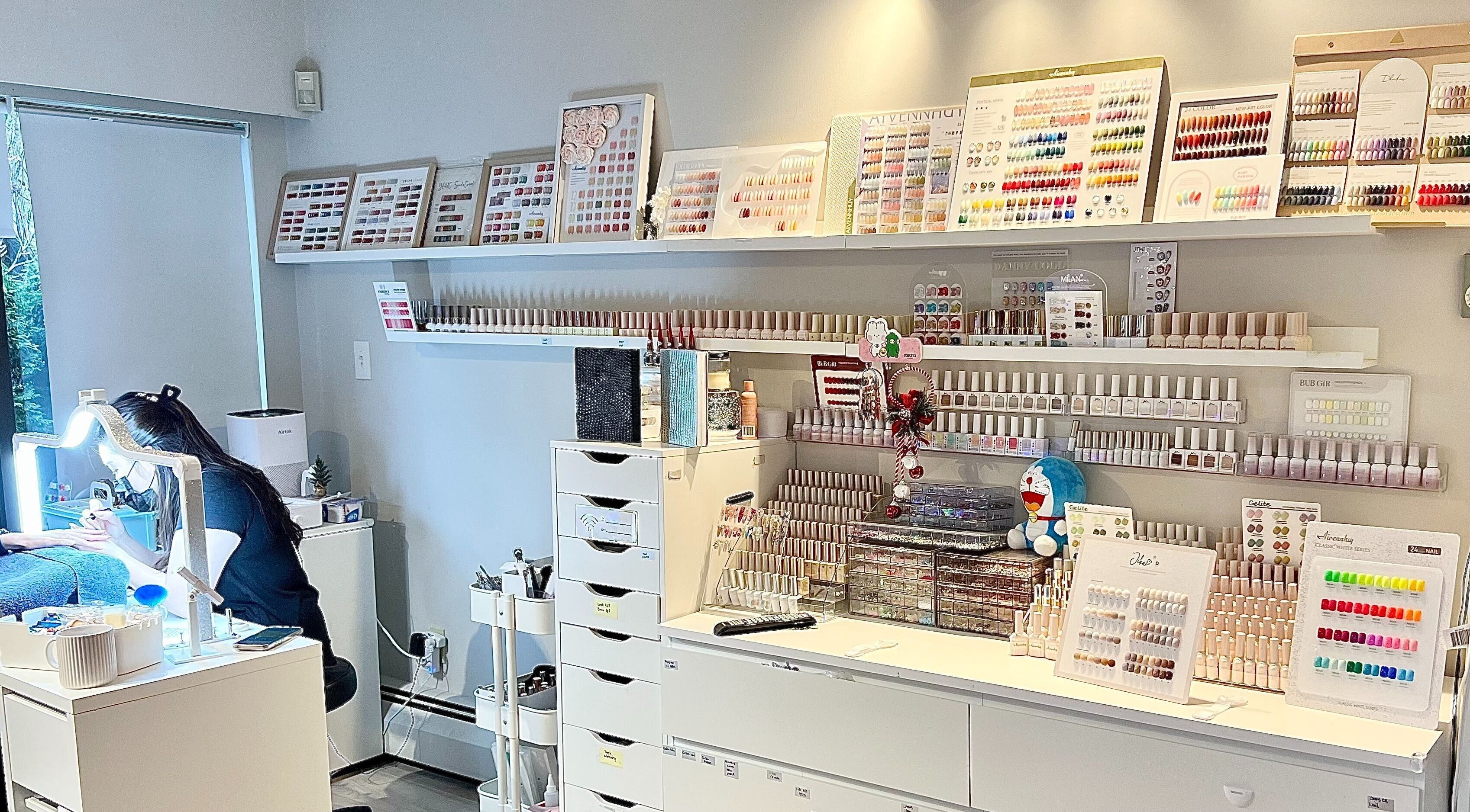 Fi Lash Nail Studio in Vancouver, BC showcases a vibrant nail polish palette and workplace setup.