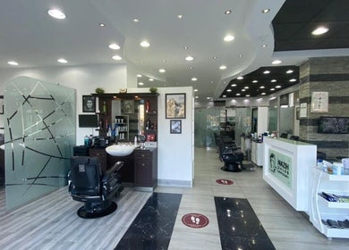 Stylish modern interior of Nazih Gents Salon - Sharjah, featuring sleek barber chairs and decor in Sharjah, AE.