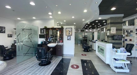 Stylish modern interior of Nazih Gents Salon - Sharjah, featuring sleek barber chairs and decor in Sharjah, AE.