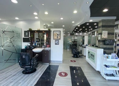 Modern interior of Nazih Gents Salon - Sharjah, Sharjah, AE, showcasing sleek barber chairs and contemporary decor.