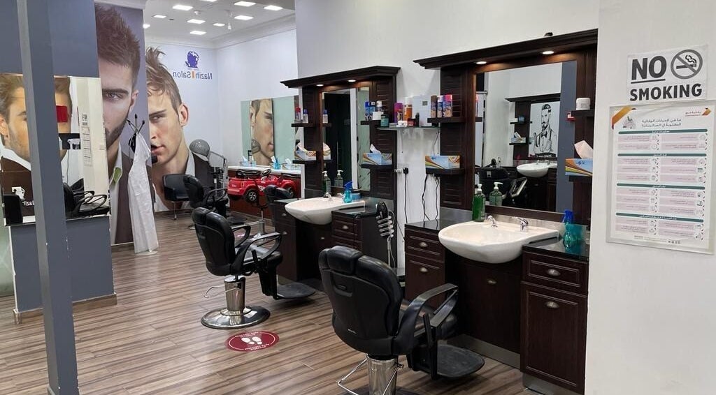 Nazih Gents Salon - Dubai interior showcasing luxury grooming chairs, mirrors, and products, دبي, دبي, AE.