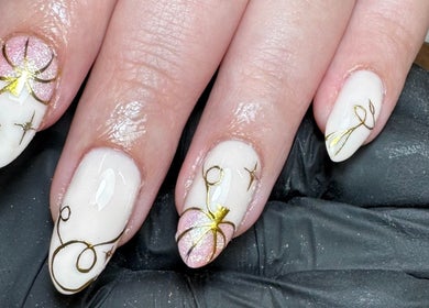 Intricate nail art featuring gold floral designs at Glossy by Nieve, Hartlepool, England, GB.
