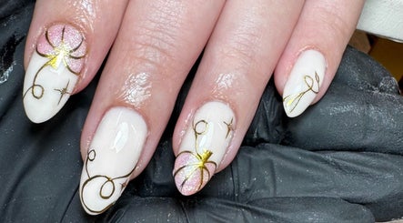Intricate nail art featuring gold floral designs at Glossy by Nieve, Hartlepool, England, GB.